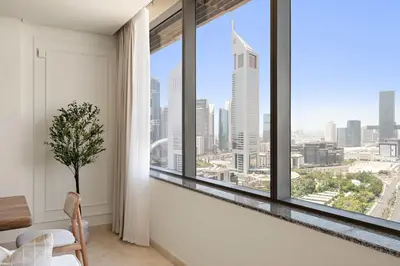 a room with a window with a view of the city at Silkhaus Urban 1BDR Escape in Heart of DIFC in Dubai