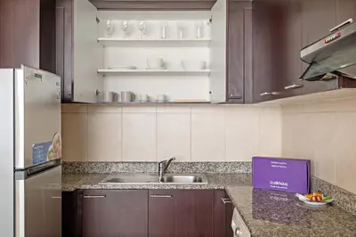 a kitchen with a sink and a counter top at Silkhaus Urban 1BDR Escape in Heart of DIFC in Dubai