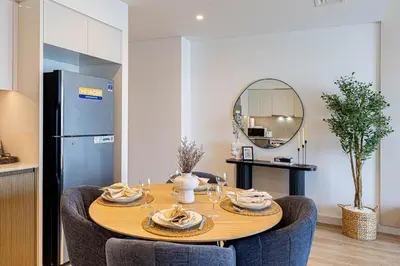 a dining room table with chairs and a mirror at Luxury 2BR Downtown ,5 min walk to Burj Khalifa and Dubai Mall in Dubai