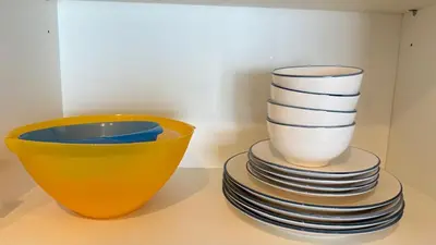 a stack of plates and a bowl on a table at Luxury 2BR Downtown ,5 min walk to Burj Khalifa and Dubai Mall in Dubai