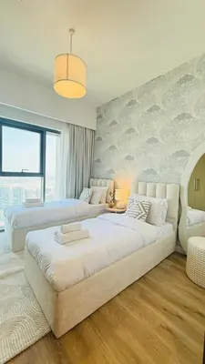 a large bedroom with two beds and a large window at Luxury 2BR Downtown ,5 min walk to Burj Khalifa and Dubai Mall in Dubai