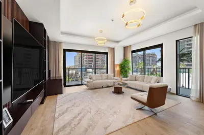 a living room with a couch and a tv at 3BR Central Park, Prime Dubai Location in Dubai