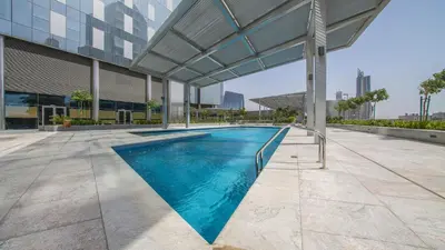 a swimming pool in the middle of a building at 3BR Central Park, Prime Dubai Location in Dubai