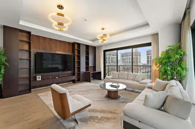 a living room with a couch and a tv at 3BR Central Park, Prime Dubai Location in Dubai
