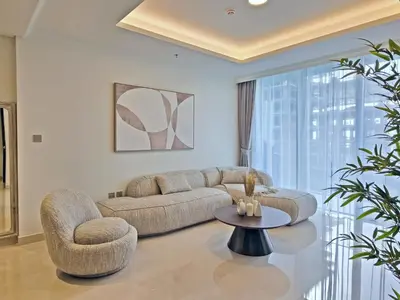 a living room with a couch and chairs and a table at Brand New 1BR , Fully Furnished in Dubai