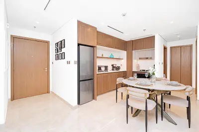 a kitchen and dining room with a table and chairs at Escape24 Luxury 1BR with Sea View and Beach Access, Dubai Harbour in Dubai