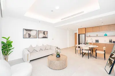 a living room with a couch and a table at Escape24 Luxury 1BR with Sea View and Beach Access, Dubai Harbour in Dubai