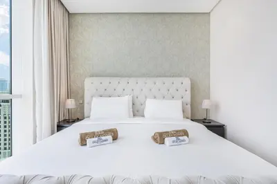 a bedroom with a large white bed with two pillows at JBR Home with incredible View & Private Beach in Dubai