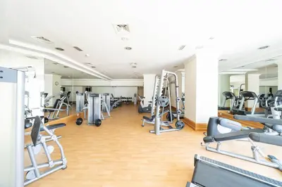 a gym with lots of treadmills and machines at JBR Home with incredible View & Private Beach in Dubai