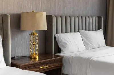 a bedroom with two beds and a lamp on a night stand at Luxury Beachfront Villa with Private Pool on Palm Jumeirah near Atlantis in Dubai