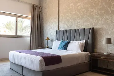 a bedroom with a large bed with a large window at Luxury Beachfront Villa with Private Pool on Palm Jumeirah near Atlantis in Dubai