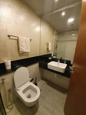 a bathroom with a toilet and a sink at Millennium Binghatti Residence - Business Bay - Homeyvillas in Dubai