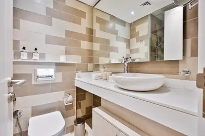 a bathroom with a sink and a toilet at Seven Palm Residence with stunning view in Dubai