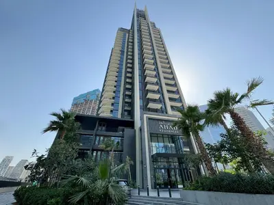 a tall building with palm trees in front of it at Ahad Residences Skyline Studio in Business Bay in Dubai