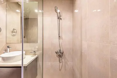 a bathroom with a shower and a sink at Lovely 1BR Business Bay near Metro - City Skyline Views in Dubai