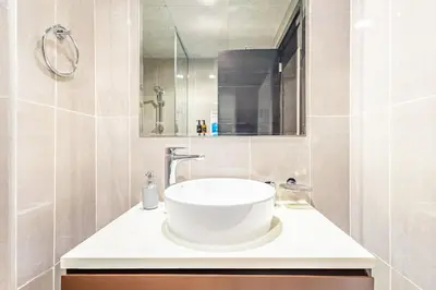 a bathroom with a sink and a mirror at Lovely 1BR Business Bay near Metro - City Skyline Views in Dubai