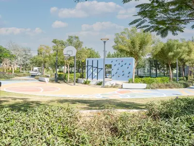a basketball court in a park with a basketball hoop at Family Friendly Villa in Tilal Al Ghaf with Garden and Padel Courts Pet Friendly in Dubai