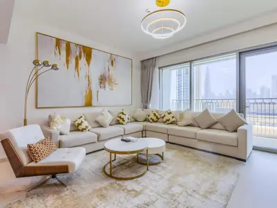 a living room with a couch and a table at TRPS - Downtown Views II Tower 2, Downtown Dubai - 3BR plus Maids - Burj Khalifa View - Walk to Dubai Mall in Dubai