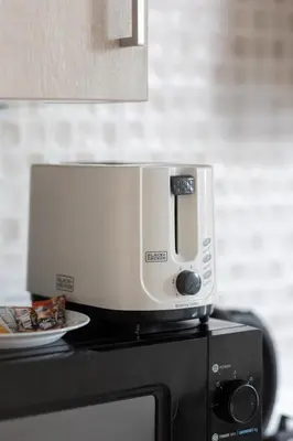 a coffeemaker sitting on top of a microwave at Elegant Beachside Studio in Prime Palm Location in Dubai