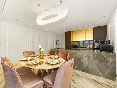 a dining room with a table and chairs at Elie Saab Collection by Luxe Manor - Dubai Mall Residences in Dubai