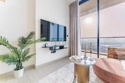 a living room with a tv and a couch at Newly Furnished Apartment near Circle Mall with Marina Views, Binghatti Onyx, JVC by Deluxe Holiday Homes in Dubai