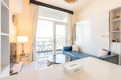 a living room with a couch and a table at Studio Near Dubai Butterfly Garden, 18 Mins Drive From Mall of Emirates, Miraclz Tower, Arjan By Deluxe Holiday Homes in Dubai