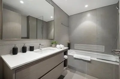a bathroom with a sink and a shower and a tub at Sky-High Luxury 2BR Burj View Walk Dubai Mall in Dubai