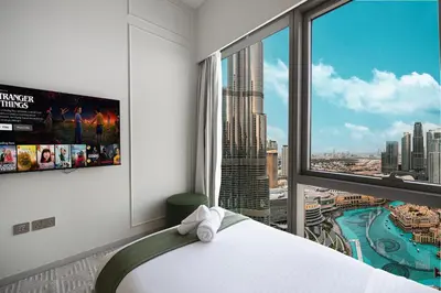 a bedroom with a large window with a view of a city at Sky-High Luxury 2BR Burj View Walk Dubai Mall in Dubai