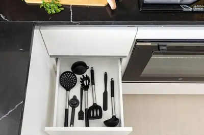 a kitchen drawer with cooking utensils in it at New 2BR with Jacuzzi and Big Balcony In City Center in Dubai