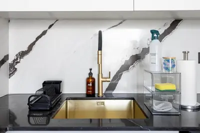 a kitchen counter with a sink with a gold sink at New 2BR with Jacuzzi and Big Balcony In City Center in Dubai