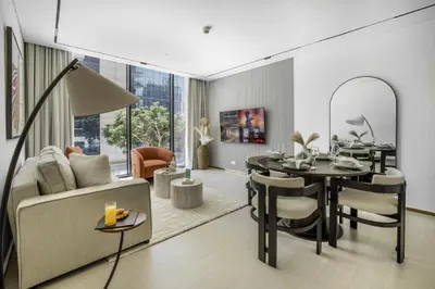 a living room with a couch and a table and chairs at New 2BR with Private Jacuzzi in City Centre in Dubai
