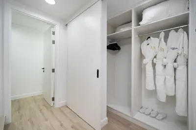 a walk in closet with white clothes and shoes at Luxury JVC 2 Bed Duplex with Private Pool and Jacuzzi in Dubai