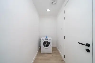 a laundry room with a washer and dryer at Luxury JVC 2 Bed Duplex with Private Pool and Jacuzzi in Dubai