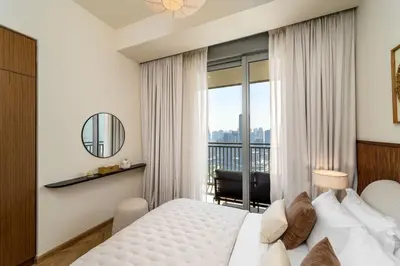 a hotel room with a bed and a balcony at Seraya Residences at 52-42 EMAAR in Dubai