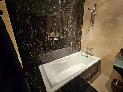 a white sink in a bathroom with a black wall at Luxury Downtown Studio - Elite Downtown Residence 1 - Burj Khalifa View Balcony in Dubai