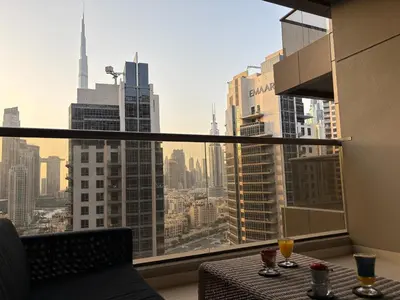 a room with a table and a view of a city at Luxury Downtown Studio - Elite Downtown Residence 1 - Burj Khalifa View Balcony in Dubai