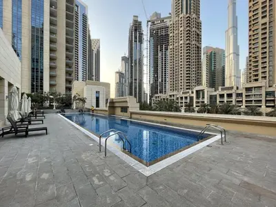 a swimming pool in a city with tall buildings at Modern 2BR in the heart of Downtown Dubai in Dubai