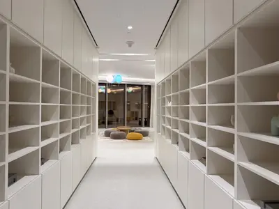 a hallway with white shelving in a building at The Skyline Burj Retreat in Dubai