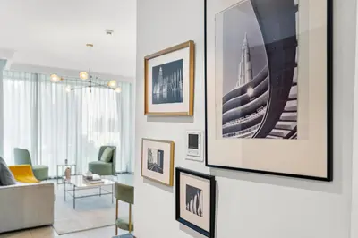 a living room with framed pictures on the wall at Burj Vista - Prime Downtown Dubai in Dubai