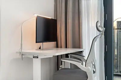 a white desk with a computer on top of it at Panoramic Marina 1BR City Skyline Views with Balcony, Pool & Gym Access in Dubai