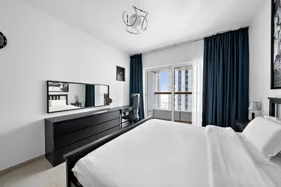 a bedroom with a large bed and a window at High-Floor 1BR at Elite Residence, Dubai Marina in Dubai