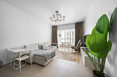 a living room with a couch and a table at High-Floor 1BR at Elite Residence, Dubai Marina in Dubai
