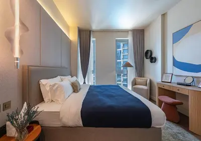 a hotel room with a large bed and a desk at Stunning 1 BR Apartment Walk to Burj Khalifa & Dubai mall in Dubai