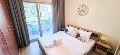 a bedroom with a bed with a large window at Cozy 1 Bed aprt in Marina Diamond 1 Tower in Dubai
