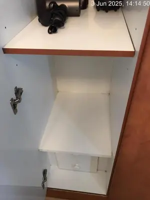 a white shelf with a camera on top of it at Cozy 1 Bed aprt in Marina Diamond 1 Tower in Dubai