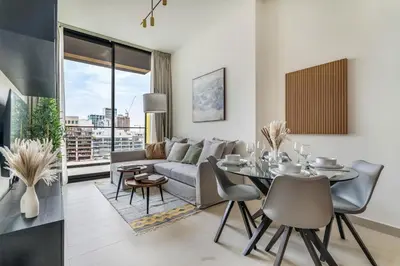 a living room with a couch and a table at DAYF-AMB Brand New Cozy 1 Bed up to 4 Guests in Dubai