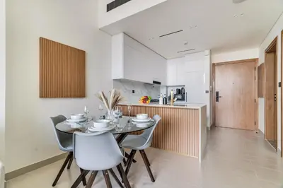 a kitchen and dining room with a table and chairs at DAYF-AMB Brand New Cozy 1 Bed up to 4 Guests in Dubai