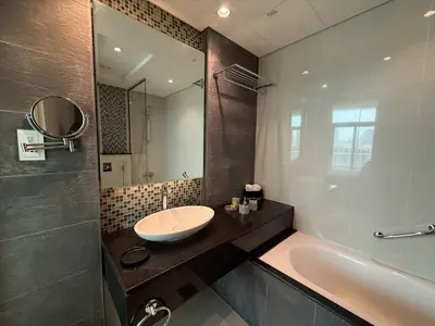 a bathroom with a sink and a bath tub at Full BurjKhalifa View - Luxury 2BR in 5Stars Hotel in Dubai