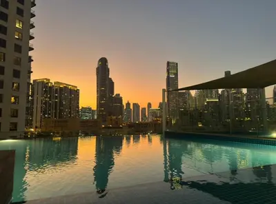 a view of a city skyline from a swimming pool at Full BurjKhalifa View - Luxury 2BR in 5Stars Hotel in Dubai