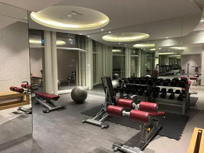 a gym with dumbbells and weights in a building at Full BurjKhalifa View - Luxury 2BR in 5Stars Hotel in Dubai